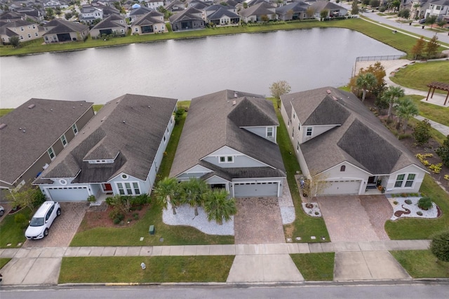 birds eye view of property with a residential view and a water view