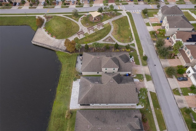 birds eye view of property with a water view and a residential view