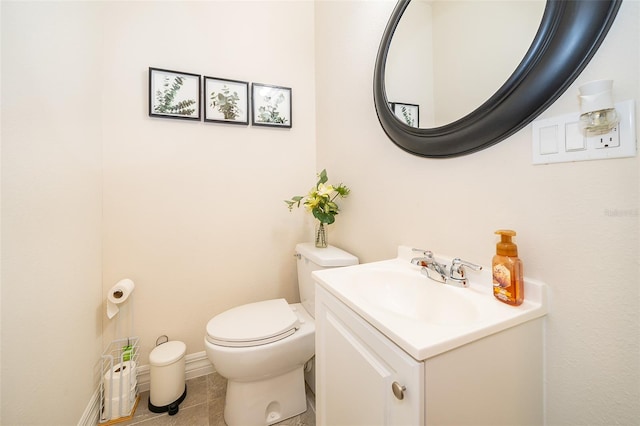bathroom with tile patterned flooring, toilet, and vanity
