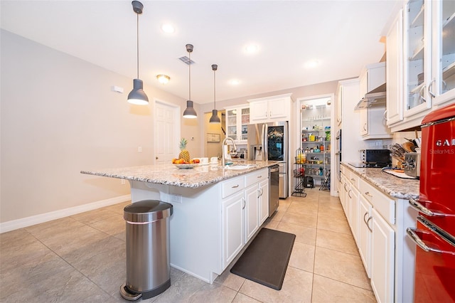 kitchen with a sink, visible vents, white cabinetry, and light tile patterned floors