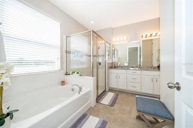 bathroom featuring a sink, a shower stall, double vanity, tile patterned flooring, and a garden tub