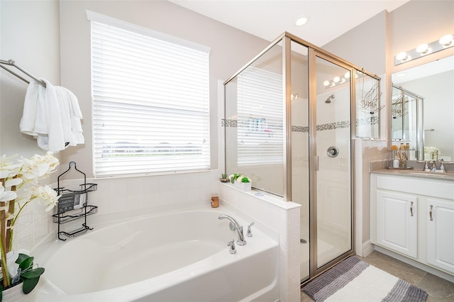 full bathroom featuring a shower stall, a bath, vanity, and tile patterned flooring