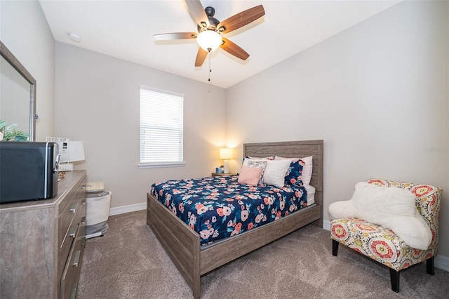 carpeted bedroom featuring baseboards and a ceiling fan