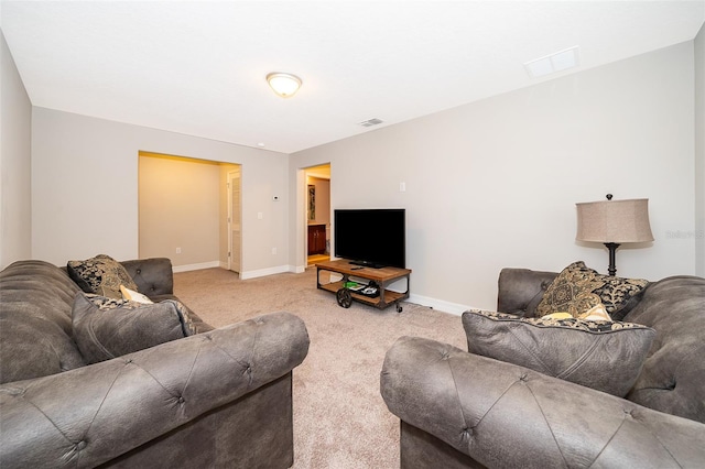 living area featuring carpet flooring, visible vents, and baseboards