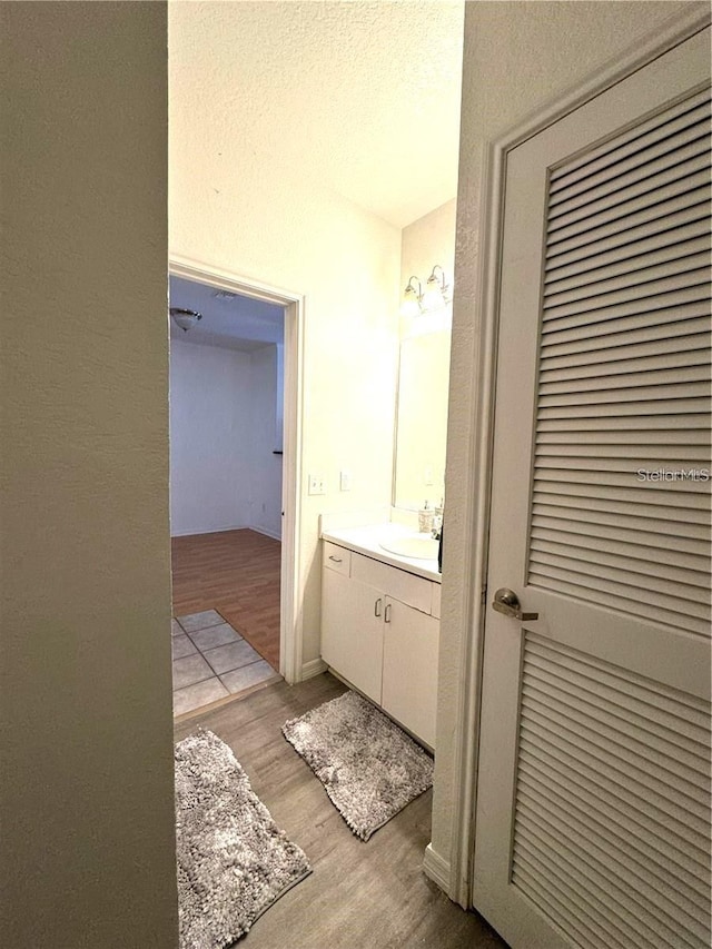 bathroom with vanity and wood finished floors