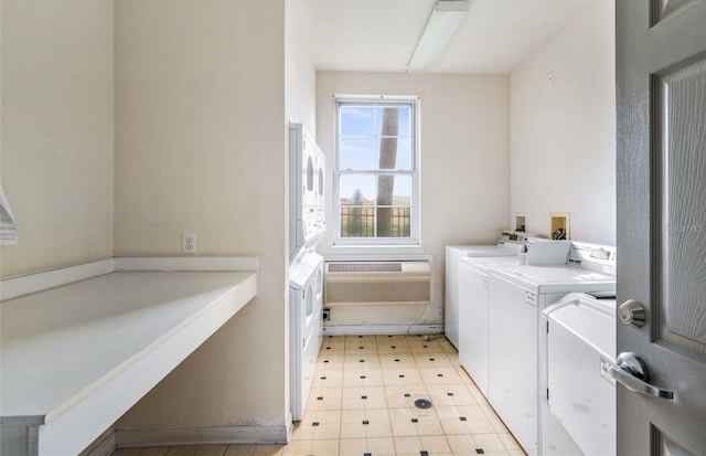 common laundry area with independent washer and dryer and a wall mounted AC
