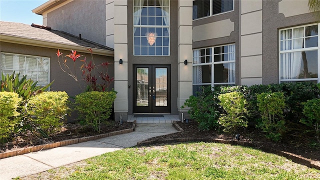 entrance to property with french doors and stucco siding