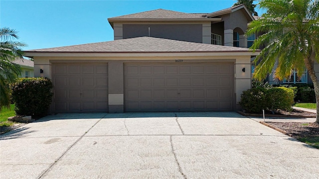 garage featuring concrete driveway