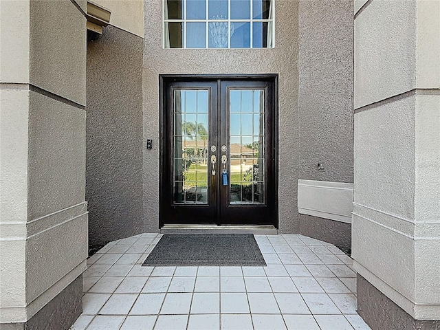 doorway to property featuring french doors and stucco siding