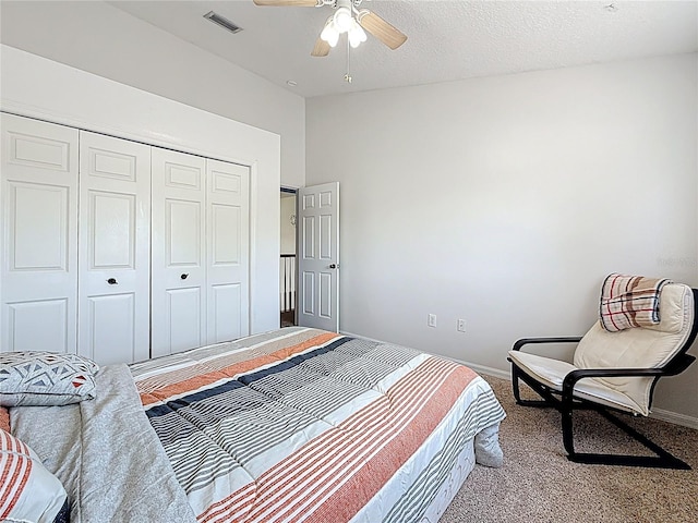 bedroom with visible vents, baseboards, a closet, and carpet