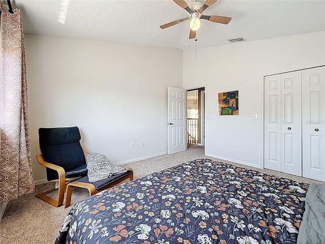 carpeted bedroom featuring ceiling fan, visible vents, baseboards, and lofted ceiling