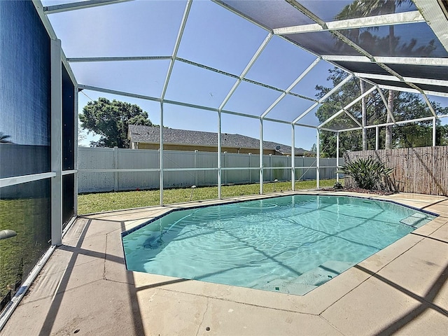 view of swimming pool featuring a patio, a fenced backyard, a fenced in pool, and glass enclosure