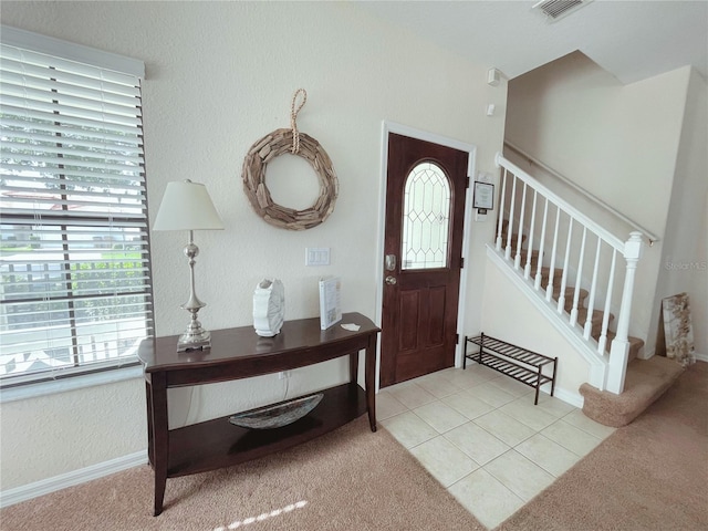 141 Summer Place Loop, Clermont, FL 34714 - foyer with light carpet, stairs, and light tile patterned floors