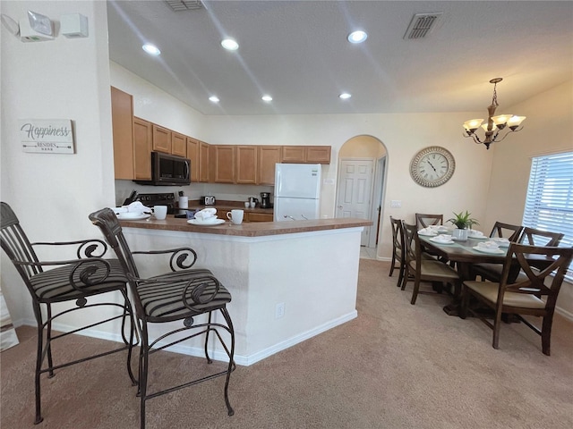 141 Summer Place Loop, Clermont, FL 34714 - kitchen featuring freestanding refrigerator, black microwave, light colored carpet, arched walkways, and a chandelier