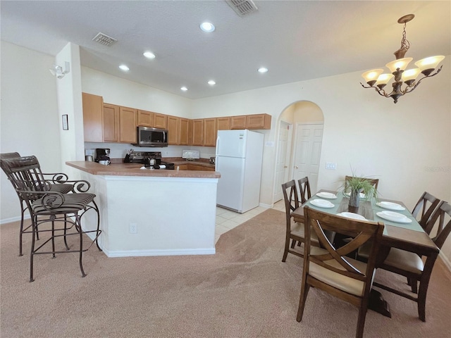 141 Summer Place Loop, Clermont, FL 34714 - kitchen featuring freestanding refrigerator, stainless steel microwave, black range with electric stovetop, light colored carpet, and a chandelier