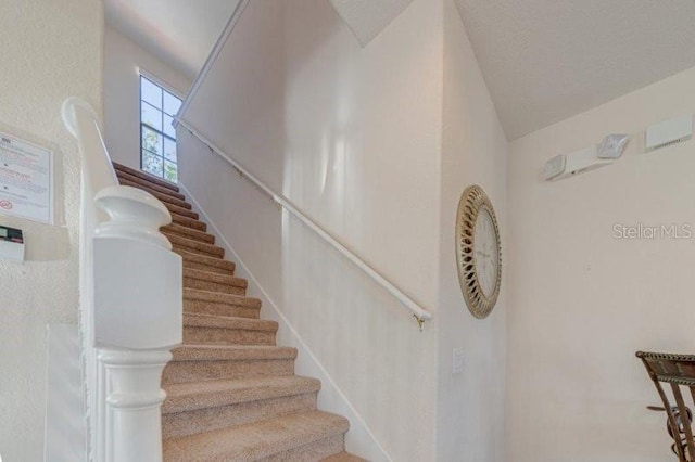 141 Summer Place Loop, Clermont, FL 34714 - staircase featuring lofted ceiling