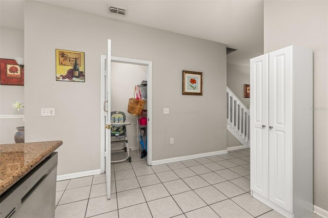 dining space featuring baseboards, visible vents, light tile patterned floors, and stairs