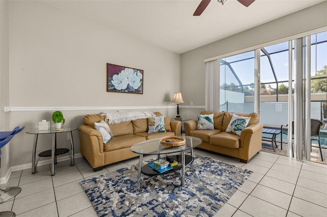 living area featuring tile patterned floors, a ceiling fan, and baseboards