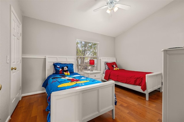 bedroom with wood finished floors, ceiling fan, and lofted ceiling