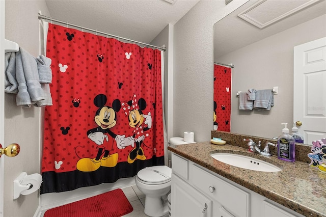 bathroom with tile patterned floors, a shower with shower curtain, toilet, and vanity