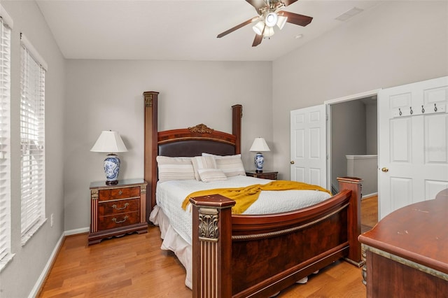 bedroom featuring a ceiling fan, baseboards, and light wood-style floors