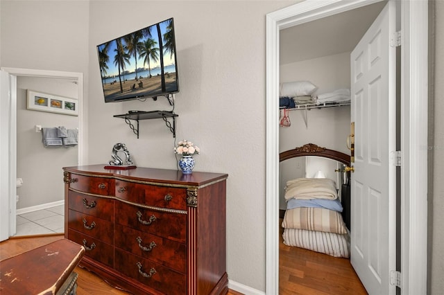 interior space featuring baseboards and wood finished floors