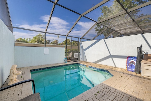 pool with a lanai and a patio area