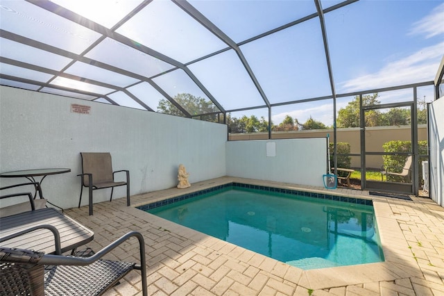 pool featuring a patio and glass enclosure