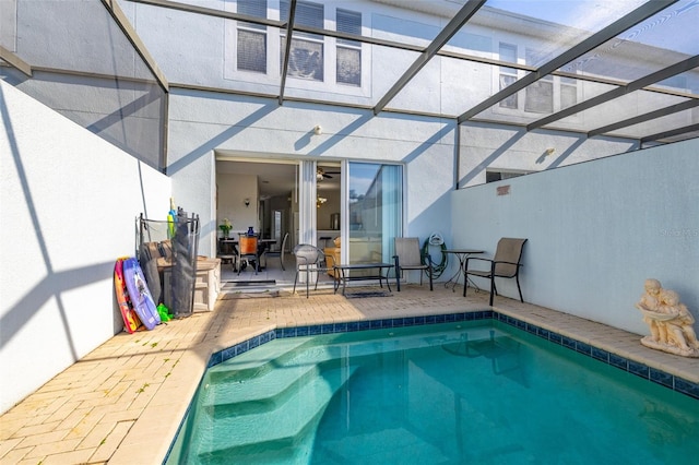 pool featuring a patio and glass enclosure