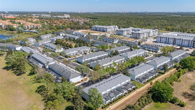 drone / aerial view with a wooded view