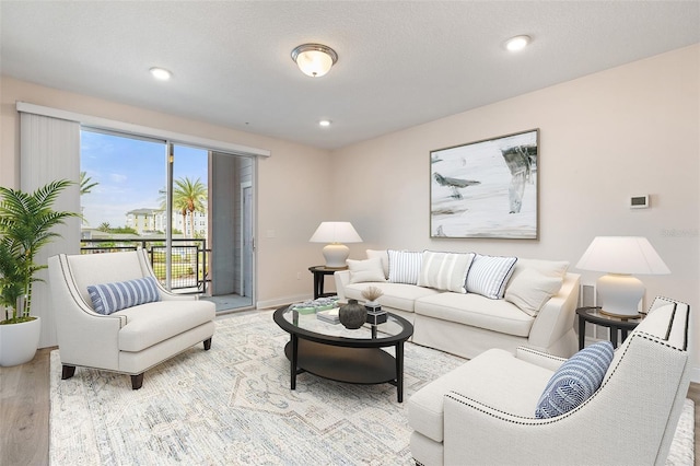 7505 Laureate Blvd Unit 2208, Orlando, FL 32827 - living room with baseboards, recessed lighting, and wood finished floors