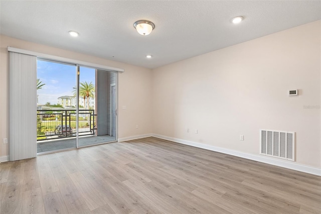 7505 Laureate Blvd Unit 2208, Orlando, FL 32827 - empty room featuring recessed lighting, visible vents, wood finished floors, and baseboards