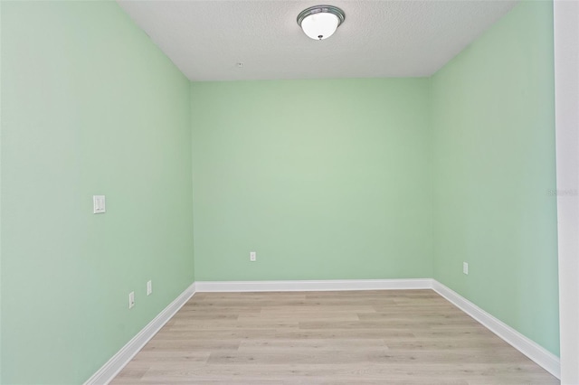 7505 Laureate Blvd Unit 2208, Orlando, FL 32827 - empty room featuring baseboards, light wood-style floors, and a textured ceiling