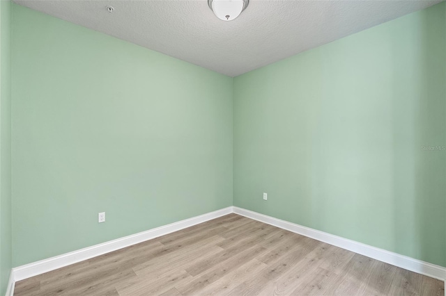 7505 Laureate Blvd Unit 2208, Orlando, FL 32827 - spare room featuring a textured ceiling, light wood finished floors, and baseboards