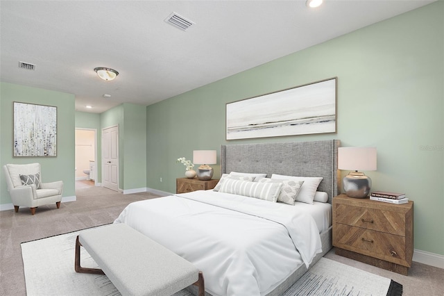 7505 Laureate Blvd Unit 2208, Orlando, FL 32827 - bedroom with visible vents, connected bathroom, light carpet, and baseboards
