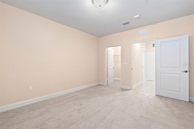 7505 Laureate Blvd Unit 2208, Orlando, FL 32827 - empty room with baseboards, visible vents, a textured ceiling, and light colored carpet
