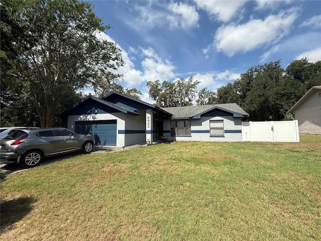 6922 Doehring Dr, Lakeland, FL 33810 - ranch-style home with an attached garage, fence, stucco siding, and a front yard