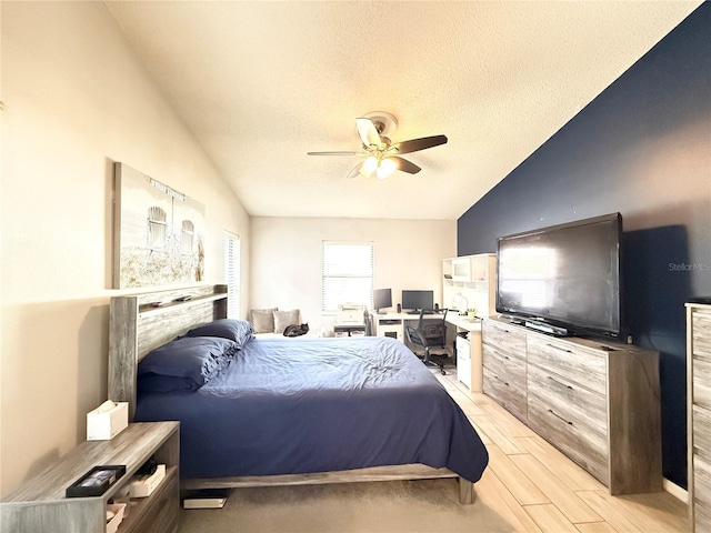 6922 Doehring Dr, Lakeland, FL 33810 - bedroom with light wood-style floors, a ceiling fan, vaulted ceiling, and a textured ceiling
