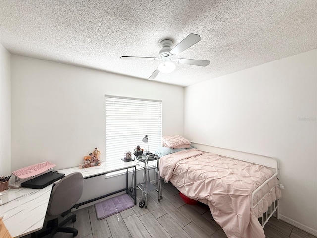 6922 Doehring Dr, Lakeland, FL 33810 - bedroom featuring wood tiled floor, a ceiling fan, and a textured ceiling