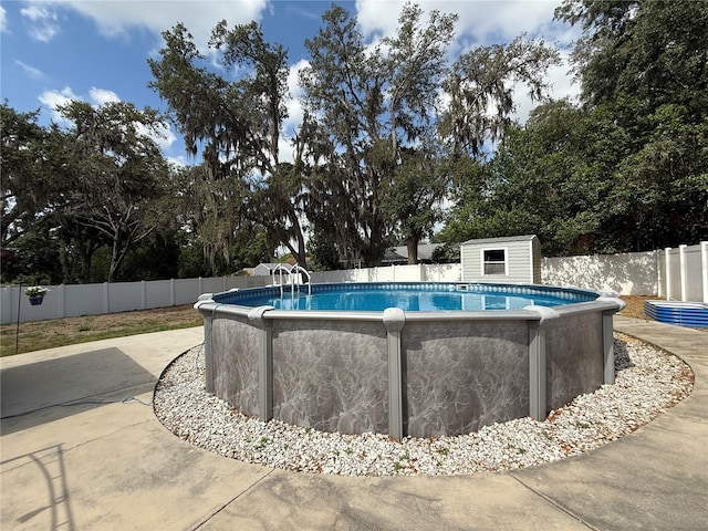 6922 Doehring Dr, Lakeland, FL 33810 - view of swimming pool featuring fence, an outbuilding, a shed, and a fenced in pool