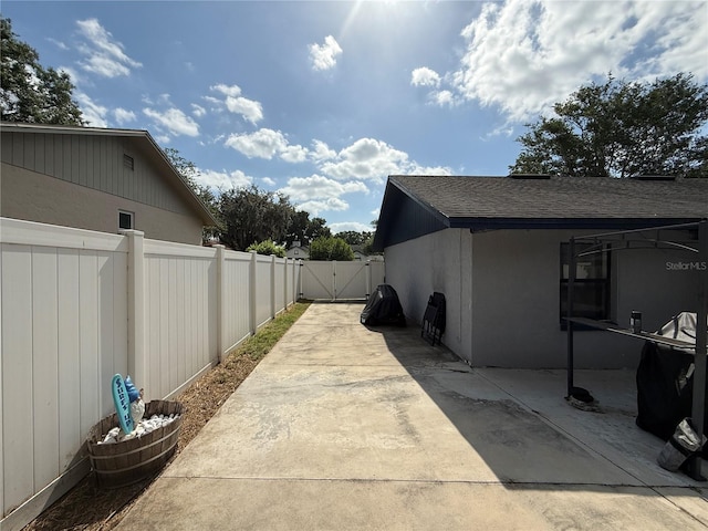 6922 Doehring Dr, Lakeland, FL 33810 - view of property exterior featuring a patio, fence, and a gate