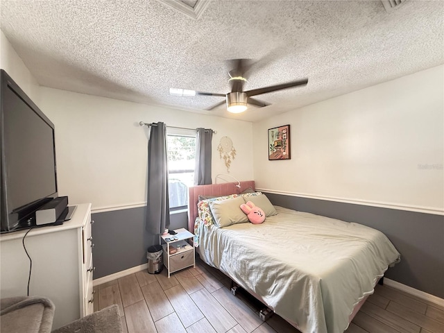 6922 Doehring Dr, Lakeland, FL 33810 - bedroom featuring baseboards, a textured ceiling, and wood finished floors