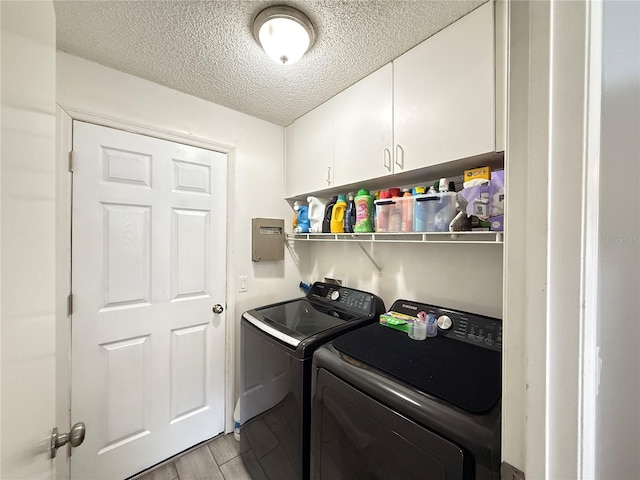 6922 Doehring Dr, Lakeland, FL 33810 - washroom with a textured ceiling, washing machine and dryer, light wood-type flooring, and cabinet space