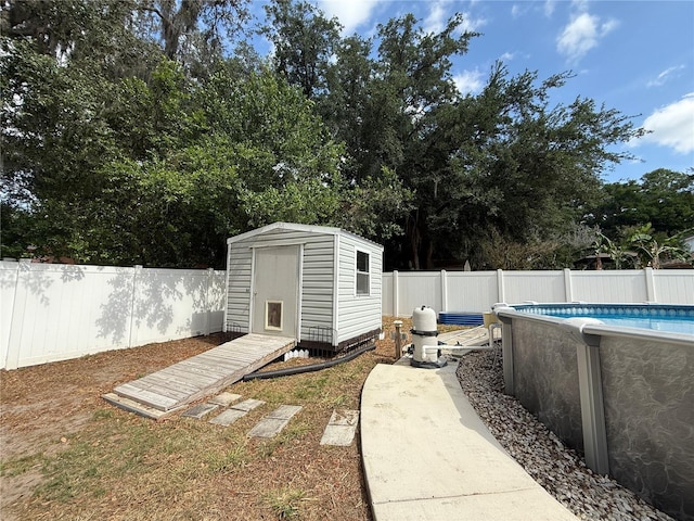 6922 Doehring Dr, Lakeland, FL 33810 - view of yard with an outdoor structure, a fenced in pool, a fenced backyard, and a storage unit