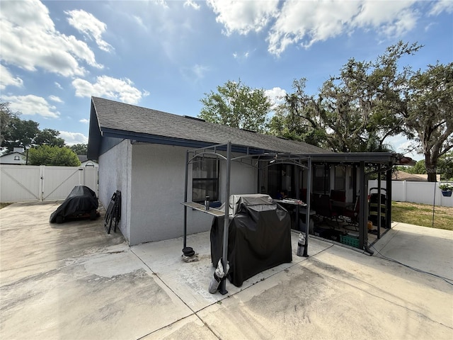 6922 Doehring Dr, Lakeland, FL 33810 - exterior space with a gate, a sunroom, fence, a patio, and stucco siding