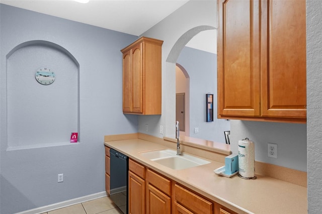 4862 Cayview Ave Unit 407, Orlando, FL 32819 - kitchen with light tile patterned floors, arched walkways, dishwasher, light countertops, and a sink