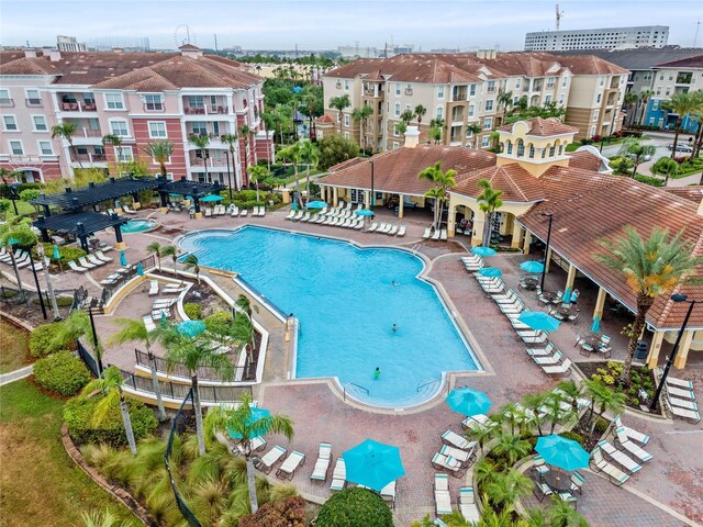 4862 Cayview Ave Unit 407, Orlando, FL 32819 - view of swimming pool with a patio and a pergola