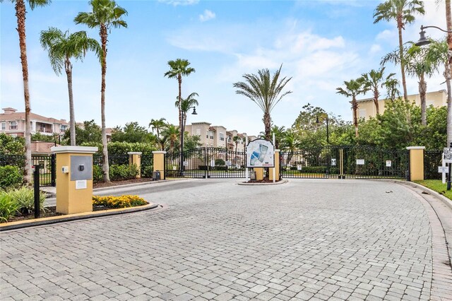 4862 Cayview Ave Unit 407, Orlando, FL 32819 - view of street featuring a residential view, a gated entry, curbs, and a gate