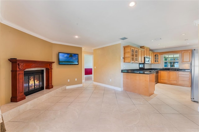 kitchen with a sink, glass insert cabinets, crown molding, and stainless steel appliances