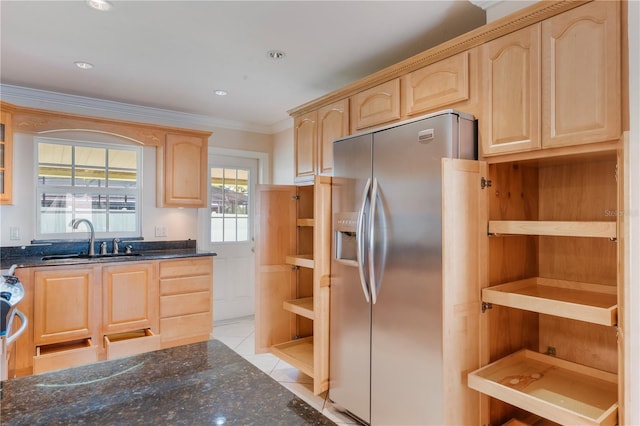 kitchen featuring light brown cabinets, stainless steel fridge, open shelves, dark stone counters, and a sink